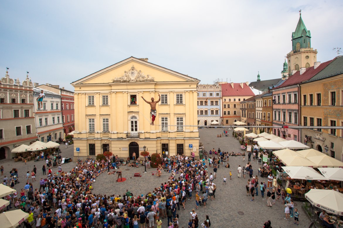 Lublin square with acrobats walking a tightrope