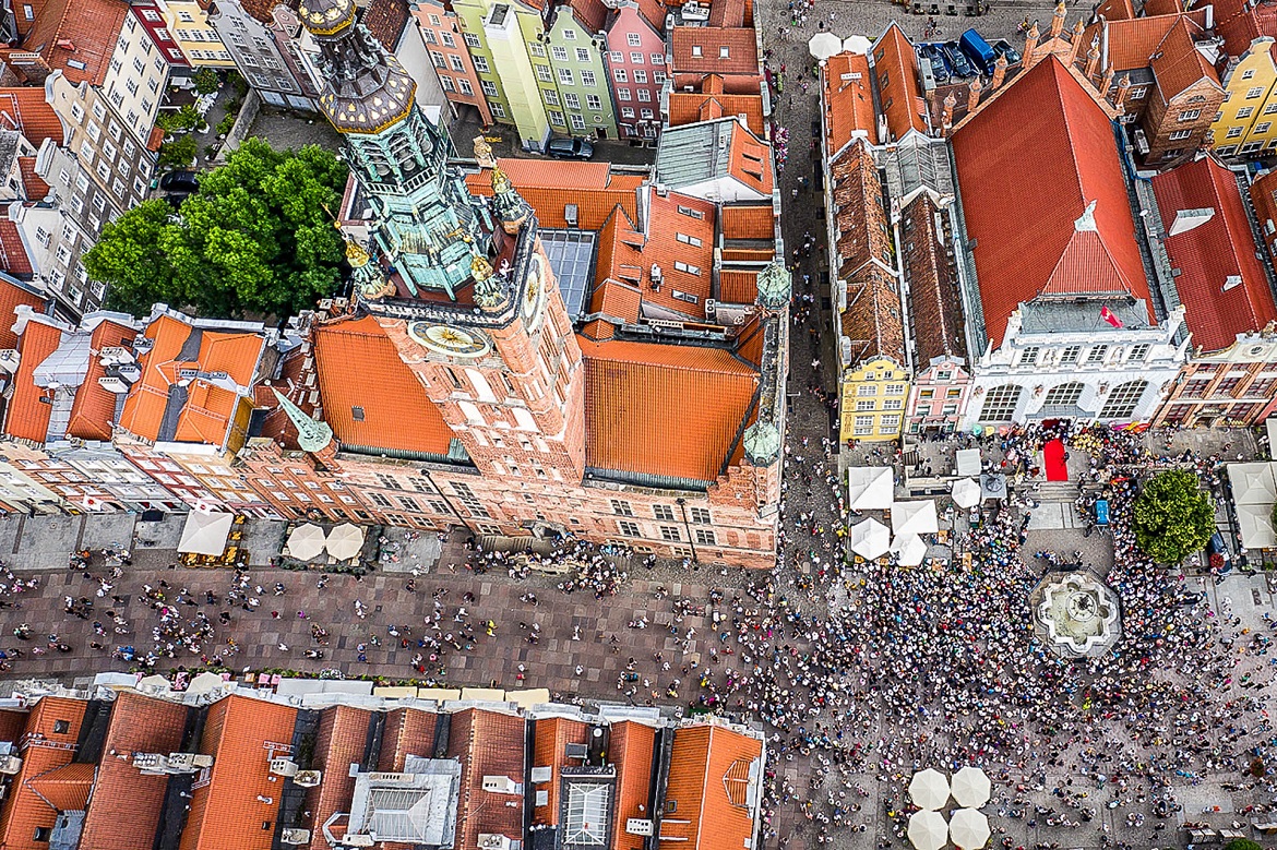 Drone view of Gdansk streets and houses with people walking about