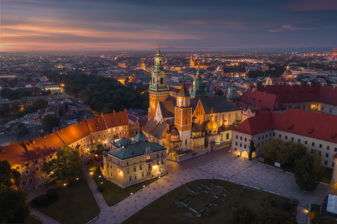 wawel castle, church spires from drone during the night
